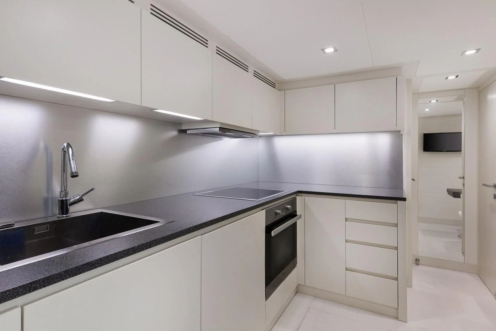 a kitchen with white cabinets aboard AFRICAN WILD DOG Yacht for Sale