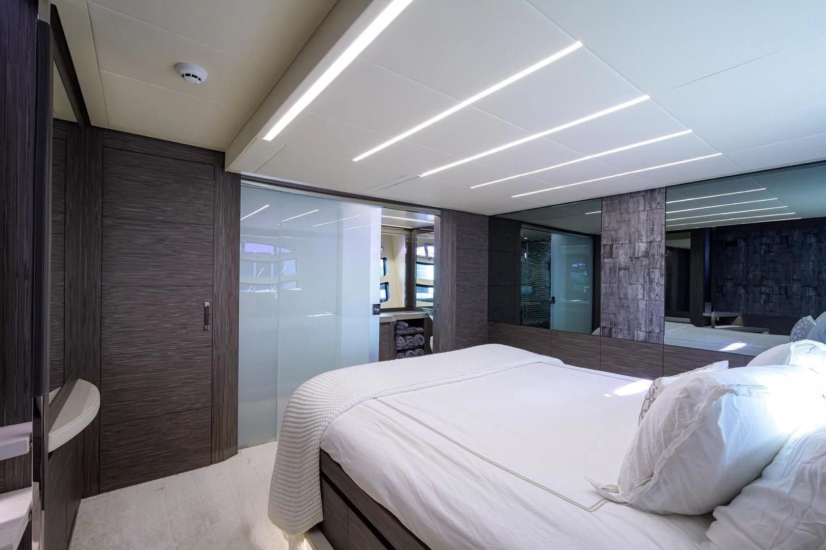 a room with a bed and a wood door aboard AFRICAN WILD DOG Yacht for Sale