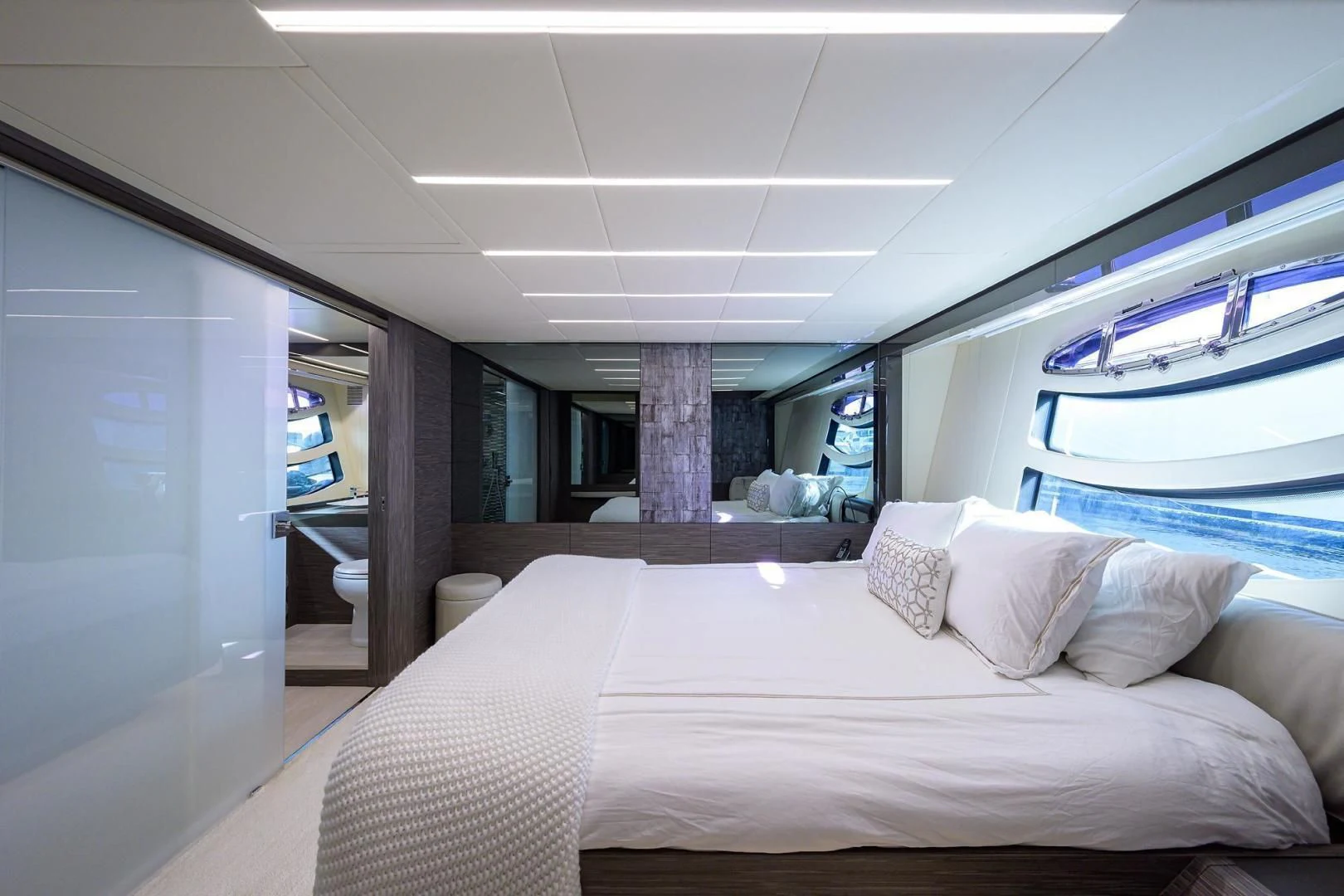 a room with a bed and a window aboard AFRICAN WILD DOG Yacht for Sale