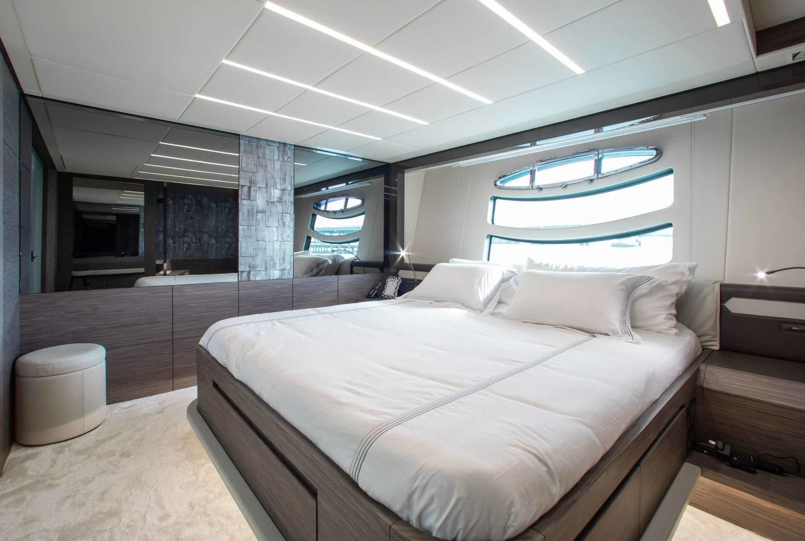 a room with a bed and a large window aboard AFRICAN WILD DOG Yacht for Sale