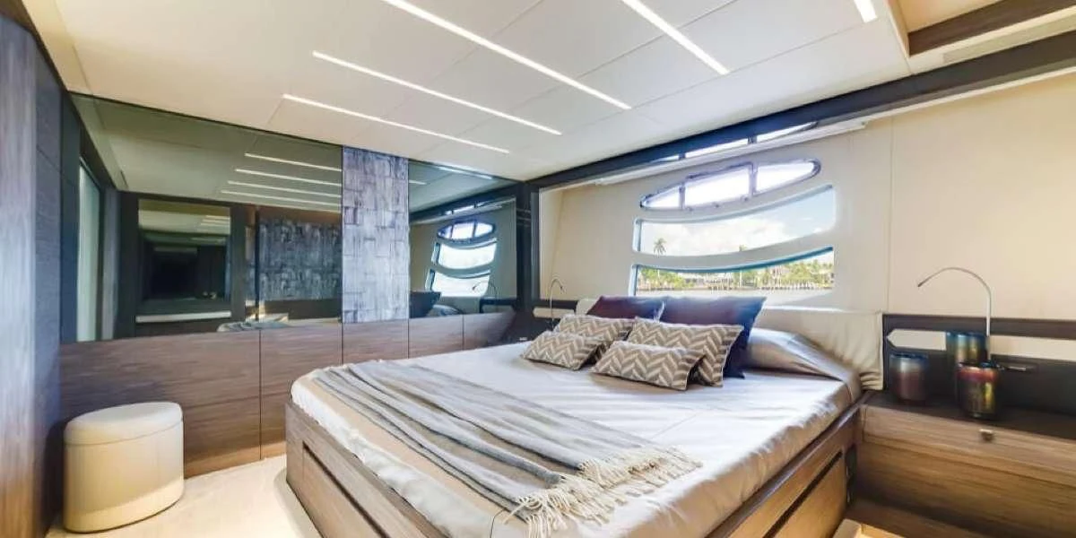 a room with a bed and a window aboard AFRICAN WILD DOG Yacht for Sale