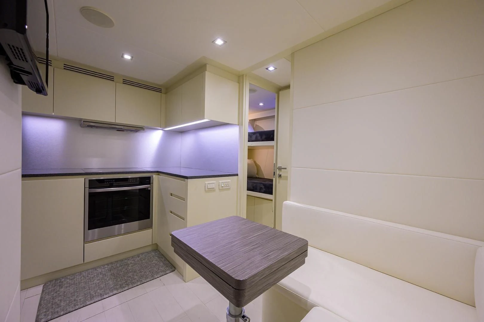a kitchen with a table and a bench aboard AFRICAN WILD DOG Yacht for Sale
