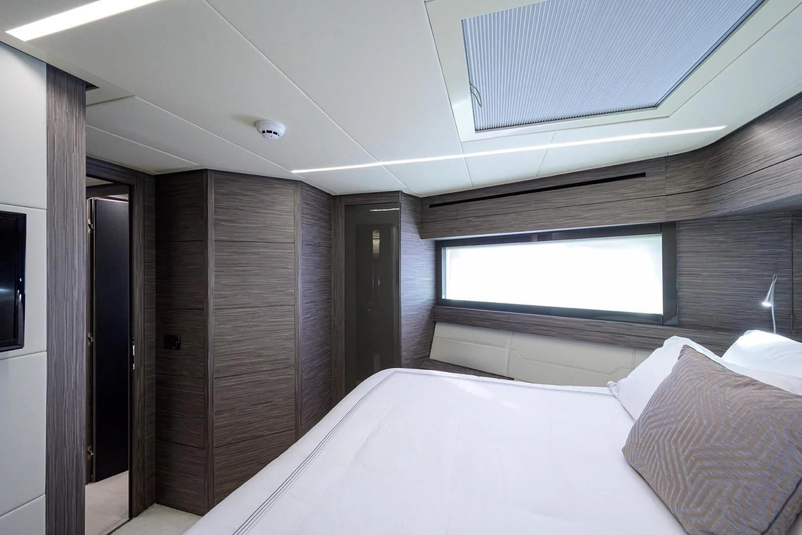 a room with a bed and a window aboard AFRICAN WILD DOG Yacht for Sale