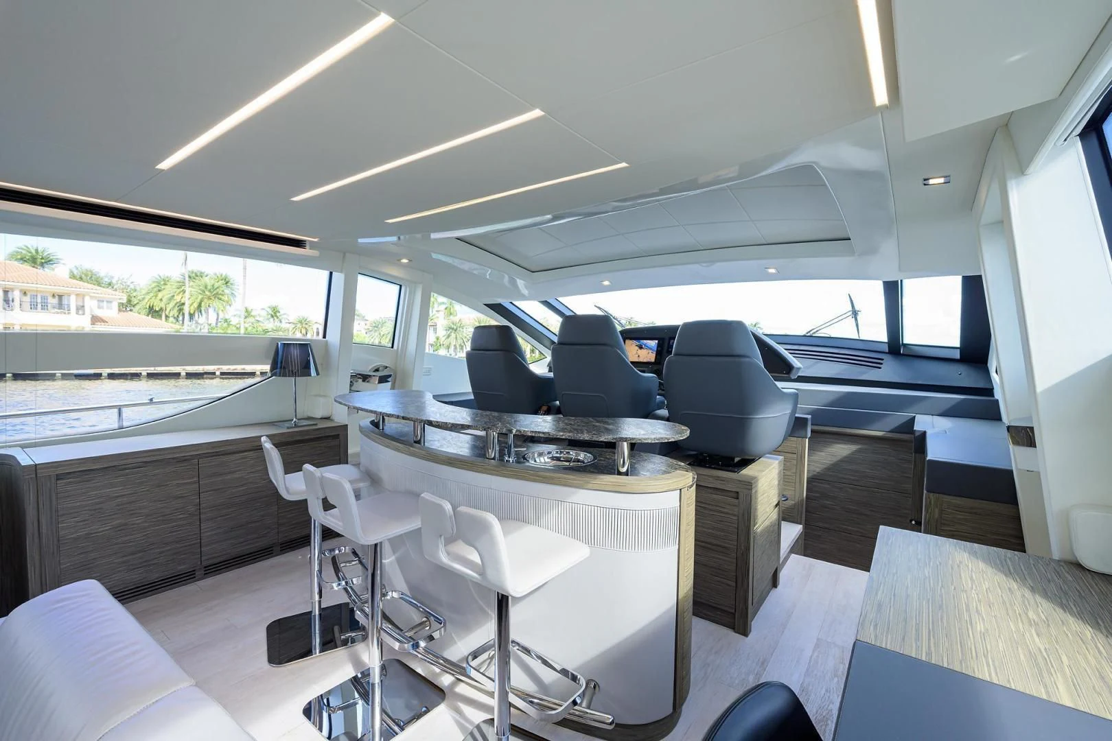 a room with a table chairs and a large window aboard AFRICAN WILD DOG Yacht for Sale