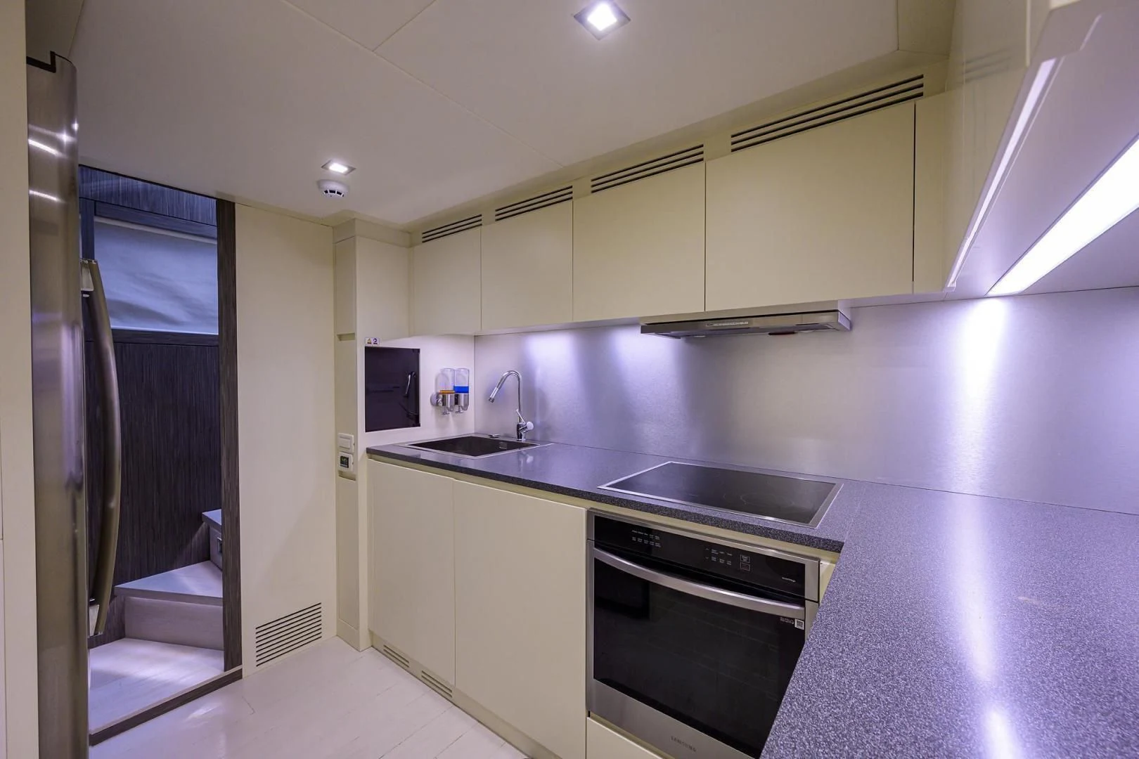a kitchen with a sink and a microwave aboard AFRICAN WILD DOG Yacht for Sale