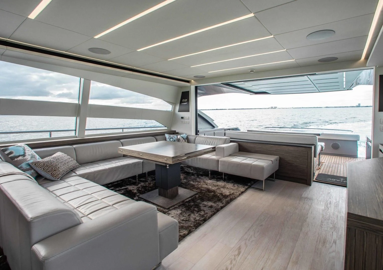a living room with a table and couches aboard AFRICAN WILD DOG Yacht for Sale