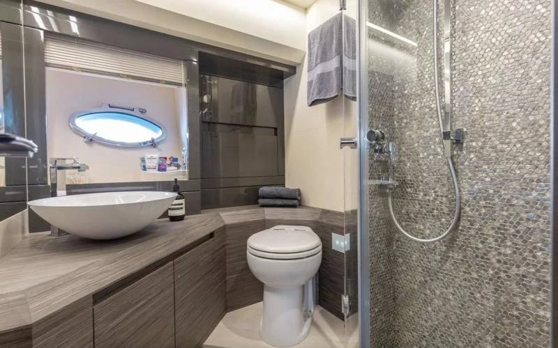 a bathroom with a glass shower aboard AFRICAN WILD DOG Yacht for Sale