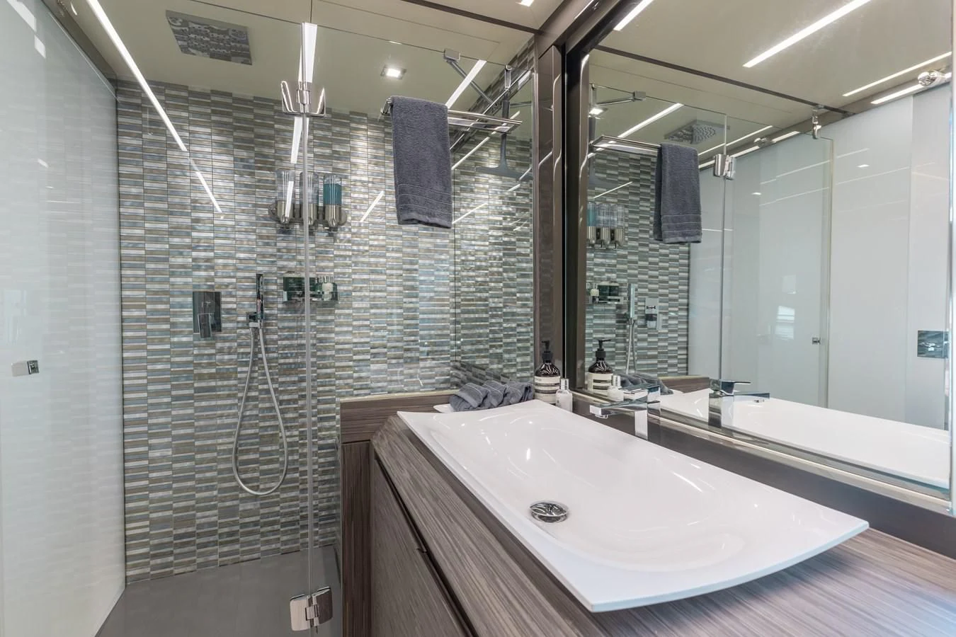 a bathroom with a bathtub and shower aboard AFRICAN WILD DOG Yacht for Sale