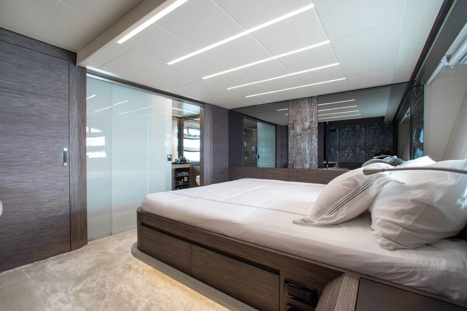 a room with a bed and a wood door aboard AFRICAN WILD DOG Yacht for Sale