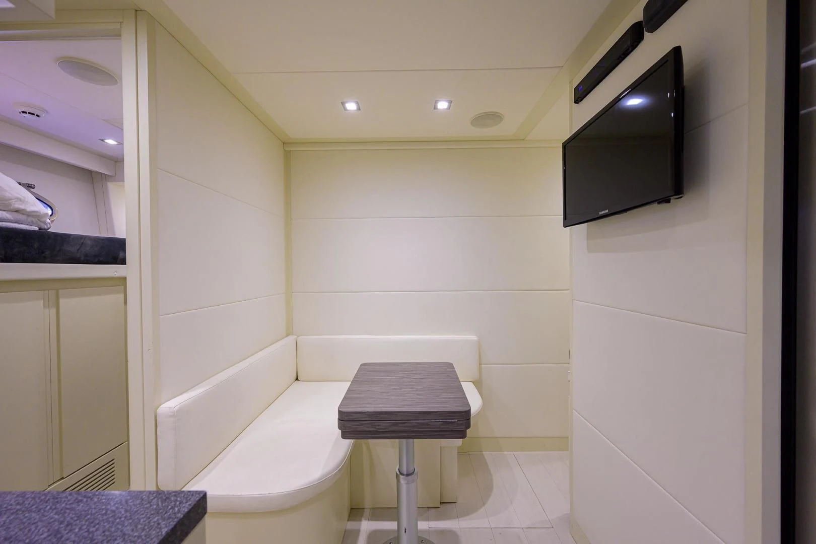 a bathroom with a toilet and a television on the wall aboard AFRICAN WILD DOG Yacht for Sale