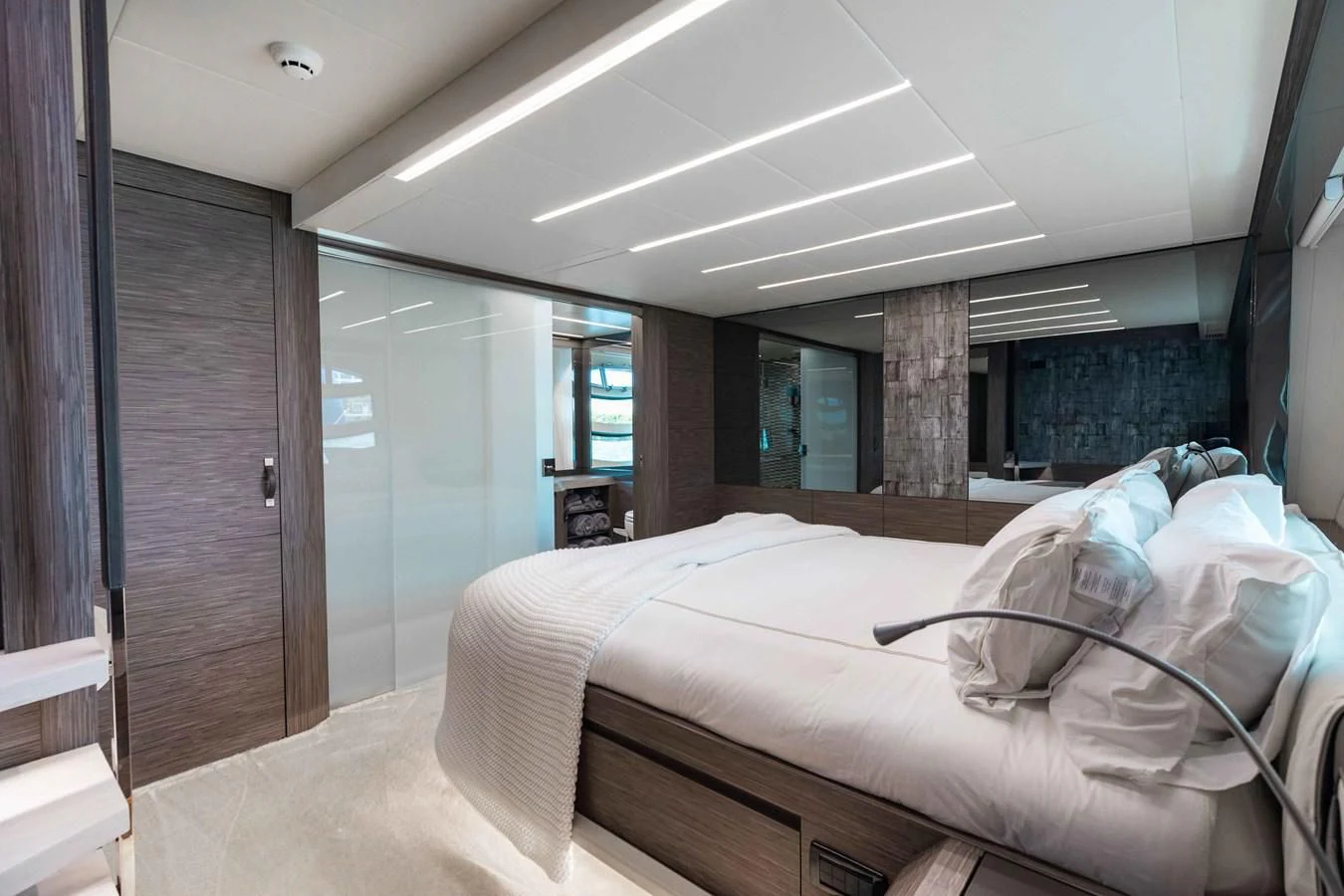 a room with a bed and a wood door aboard AFRICAN WILD DOG Yacht for Sale