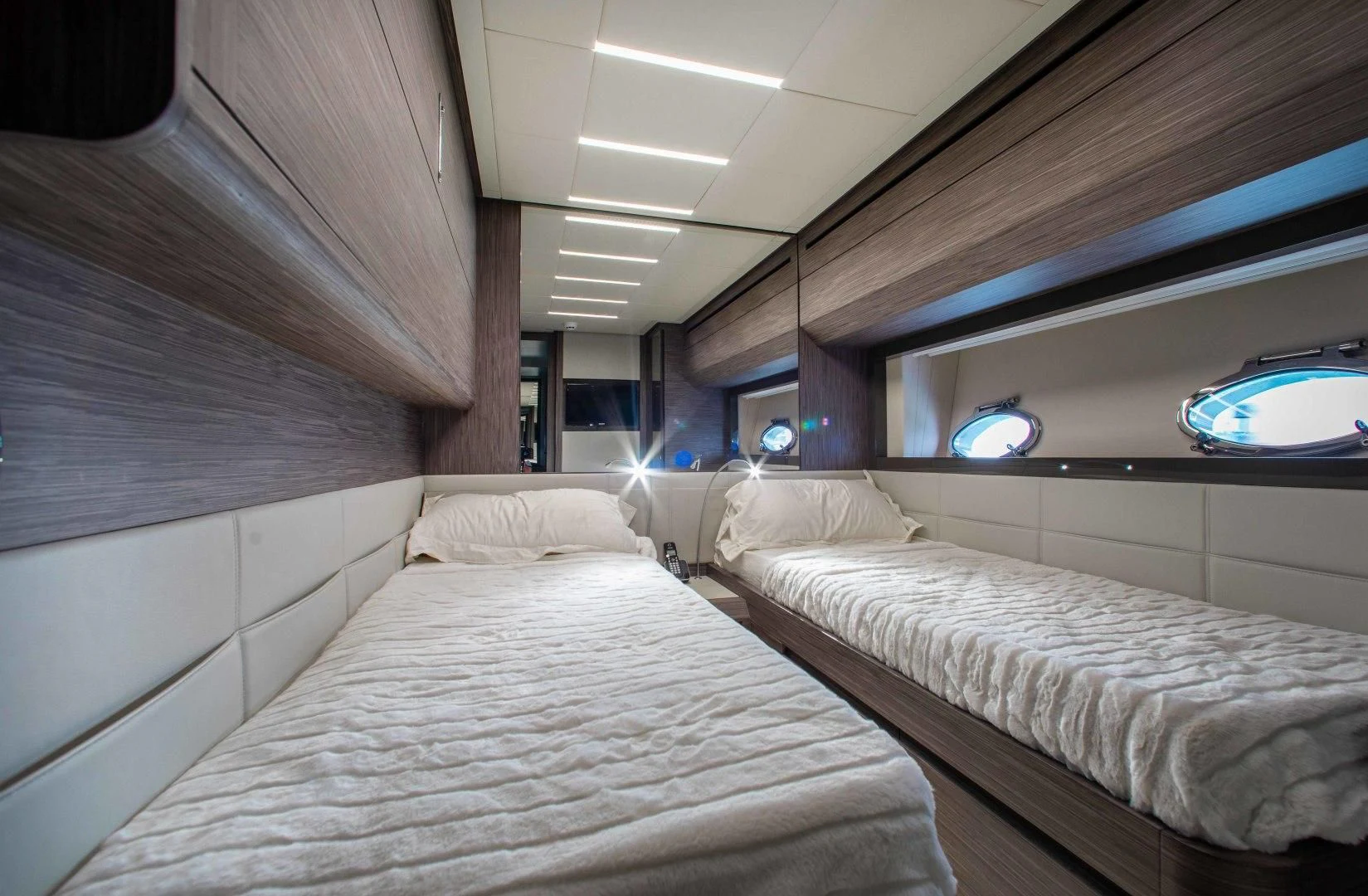 a room with beds and a window aboard AFRICAN WILD DOG Yacht for Sale