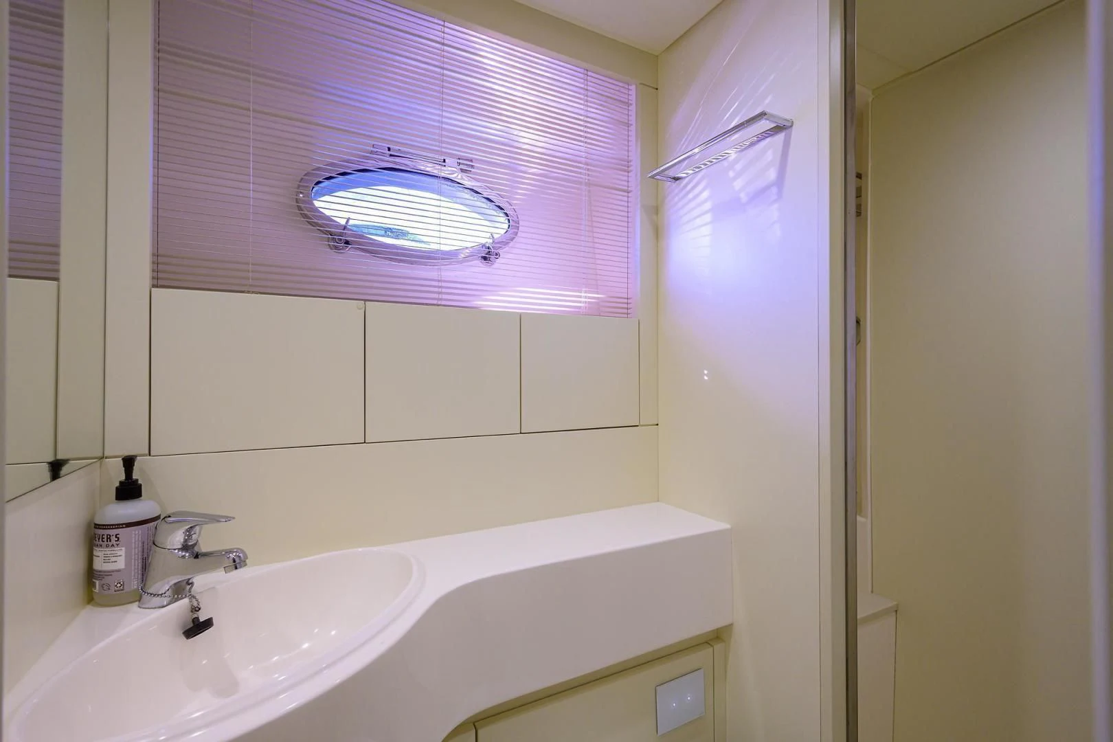 a bathroom with a sink and a window aboard AFRICAN WILD DOG Yacht for Sale