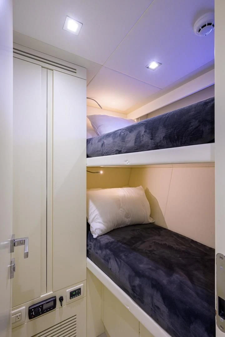 a room with a bed and a door aboard AFRICAN WILD DOG Yacht for Sale