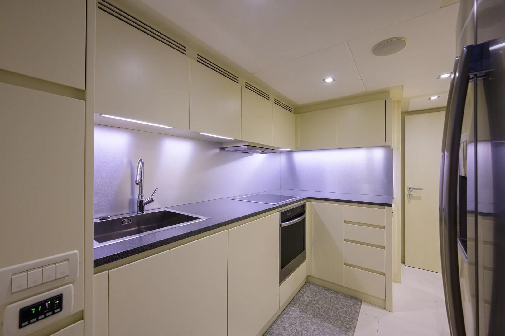 a kitchen with white cabinets aboard AFRICAN WILD DOG Yacht for Sale