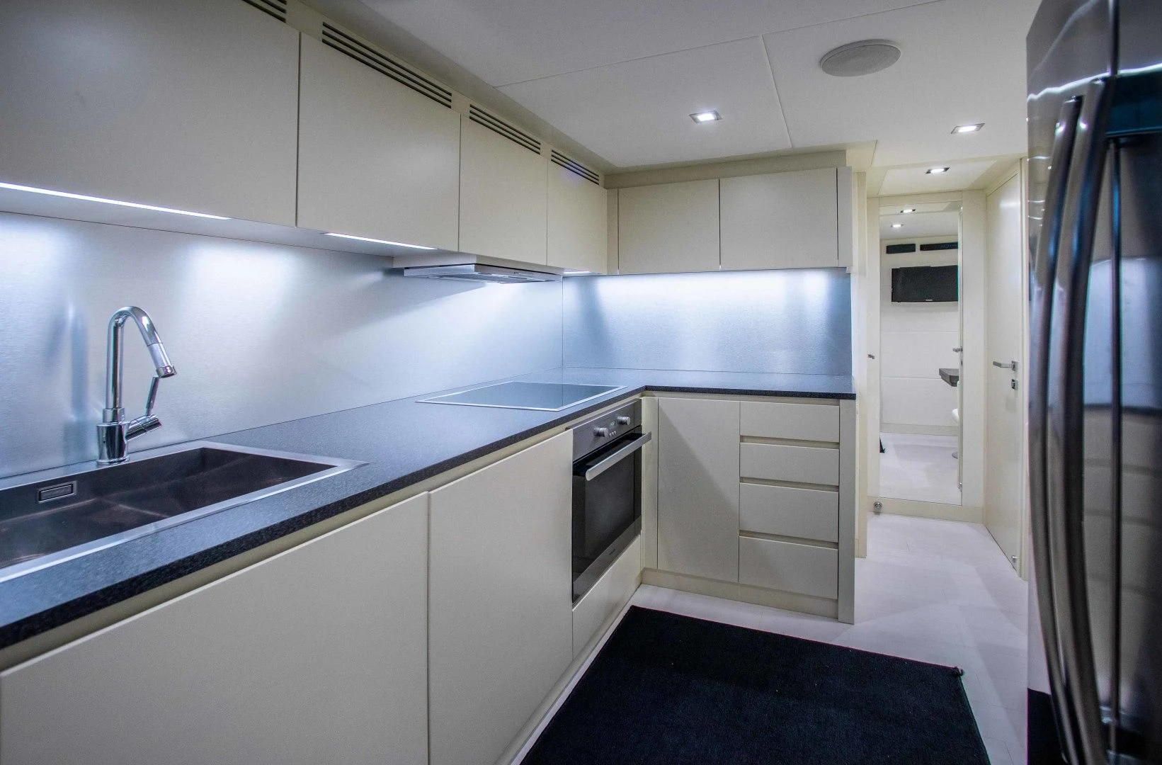 a kitchen with white cabinets aboard AFRICAN WILD DOG Yacht for Sale