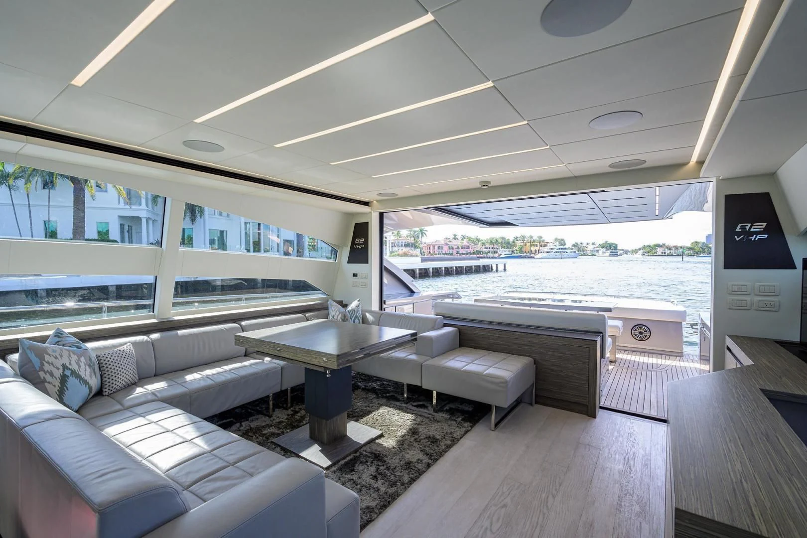 a room with a table and couches aboard AFRICAN WILD DOG Yacht for Sale