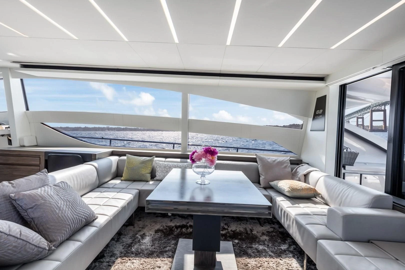 a living room with a large window aboard AFRICAN WILD DOG Yacht for Sale