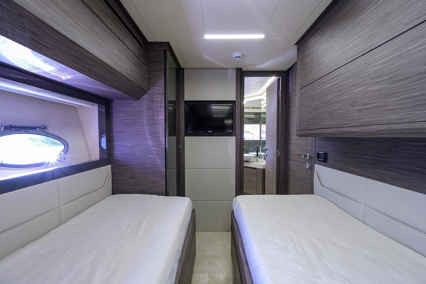 a room with a bed and a television aboard AFRICAN WILD DOG Yacht for Sale