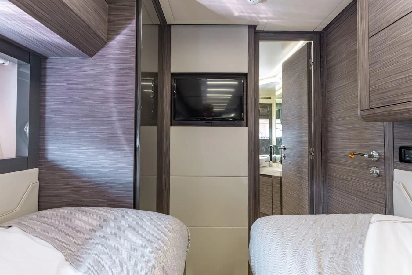 a bedroom with a bed and a television aboard AFRICAN WILD DOG Yacht for Sale