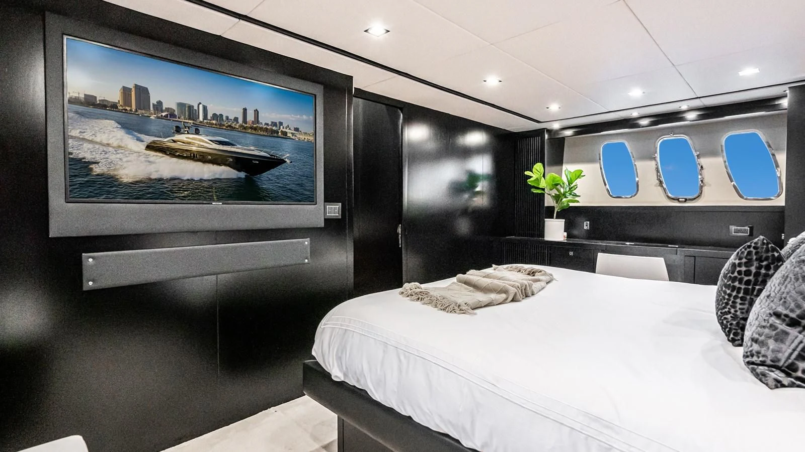 a room with a bed and a tv on the wall aboard NORMA JEAN Yacht for Sale