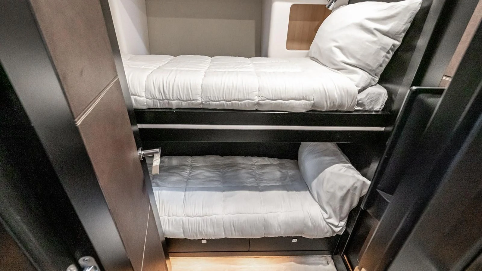 a bed with white sheets aboard NORMA JEAN Yacht for Sale
