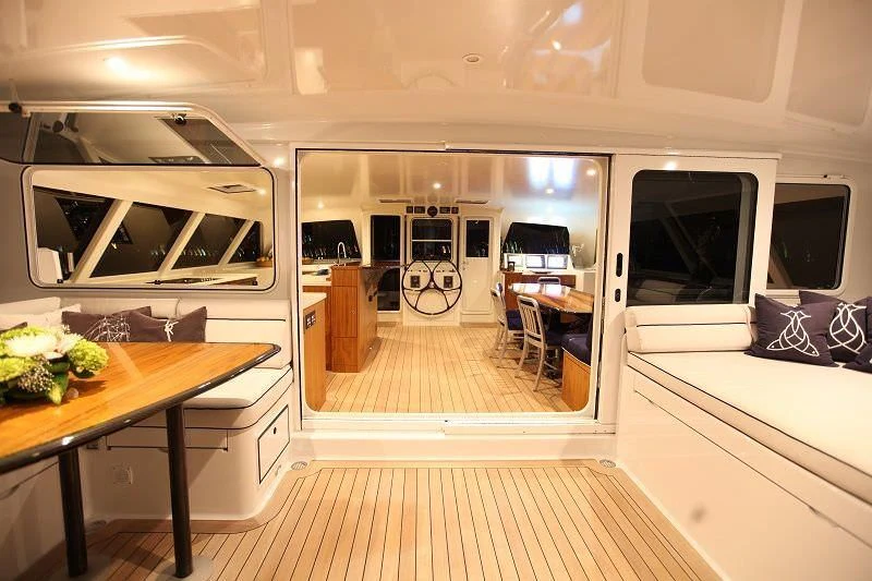 a room with a table and chairs aboard SLIM Yacht for Charter
