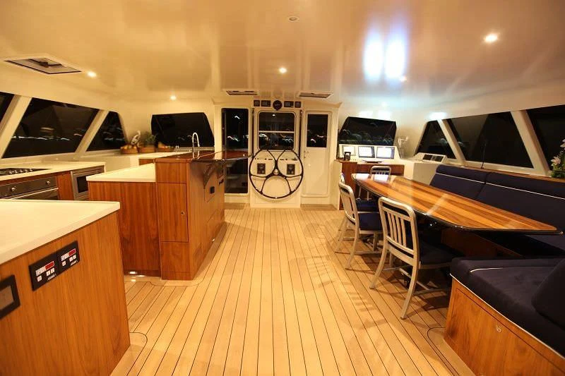 a large kitchen with a large island aboard SLIM Yacht for Charter