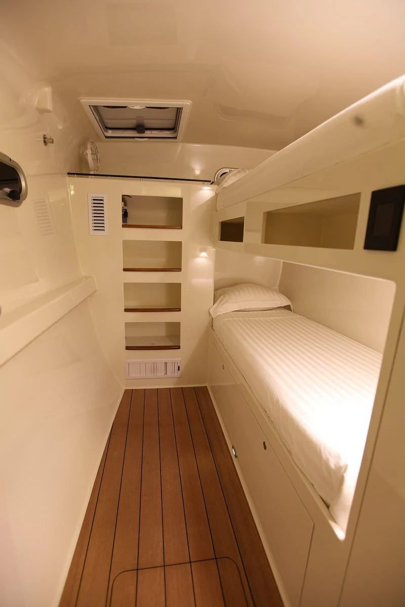 a small white room with a bed aboard SLIM Yacht for Charter