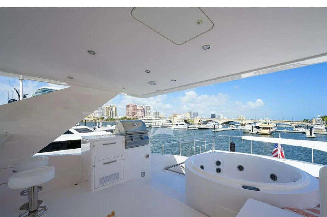 a large white bathtub in a room with a view of a city aboard RISK TAKER Yacht for Charter