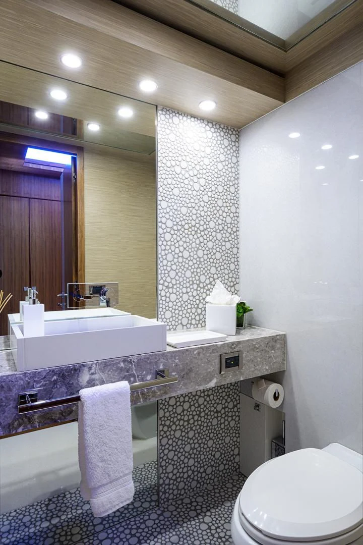 a bathroom with a sink and a toilet aboard RISK TAKER Yacht for Charter