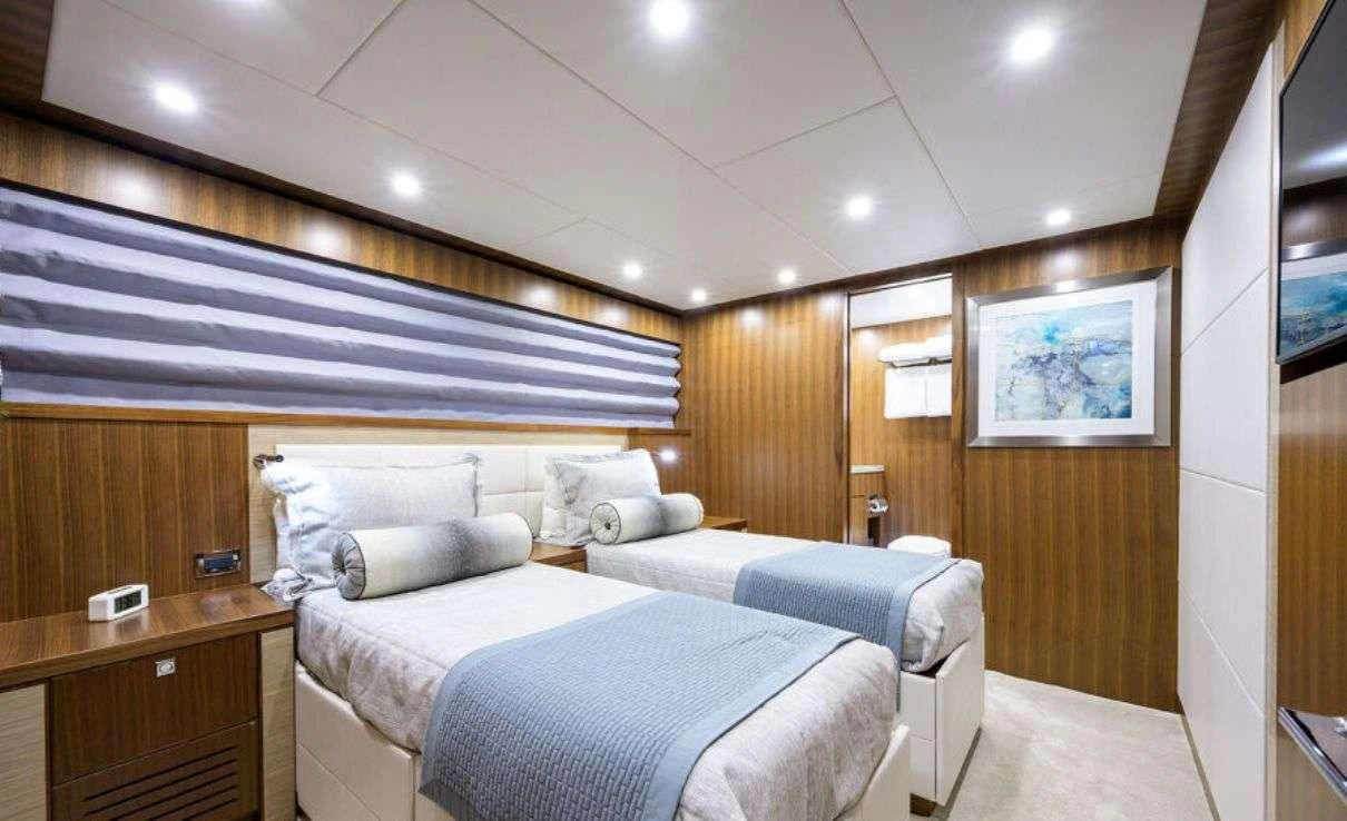 a room with a couple of beds aboard RISK TAKER Yacht for Charter