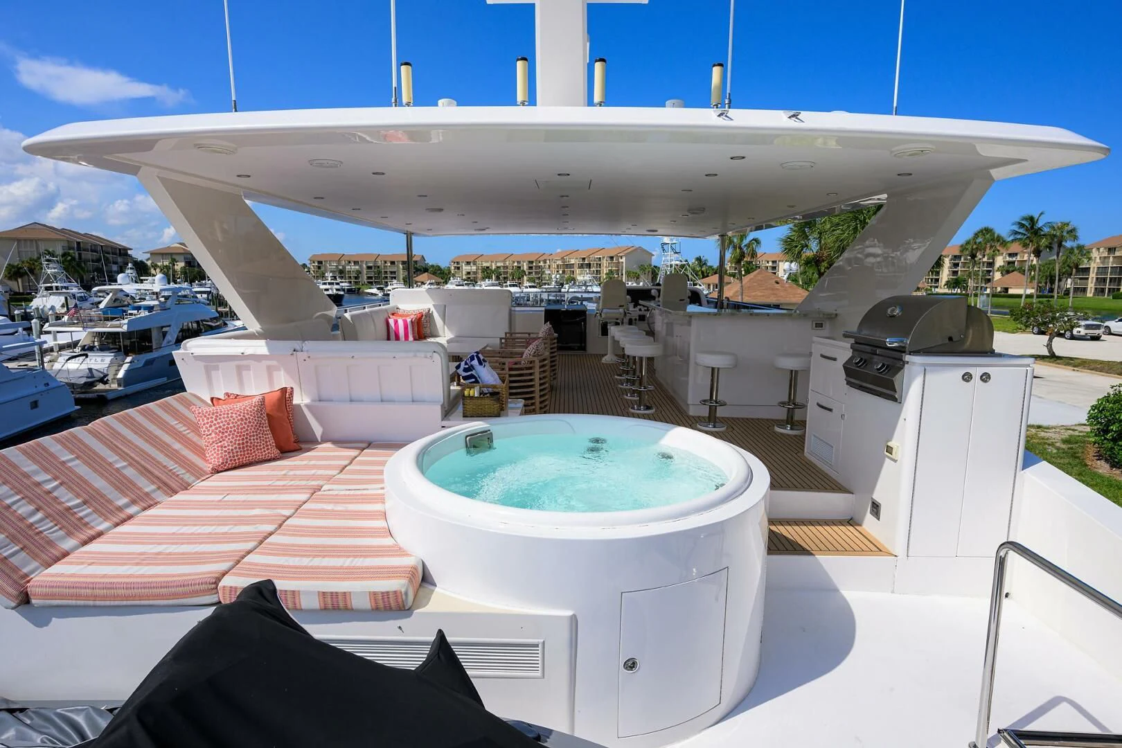 a large white building with a pool in front of it aboard RISK TAKER Yacht for Charter