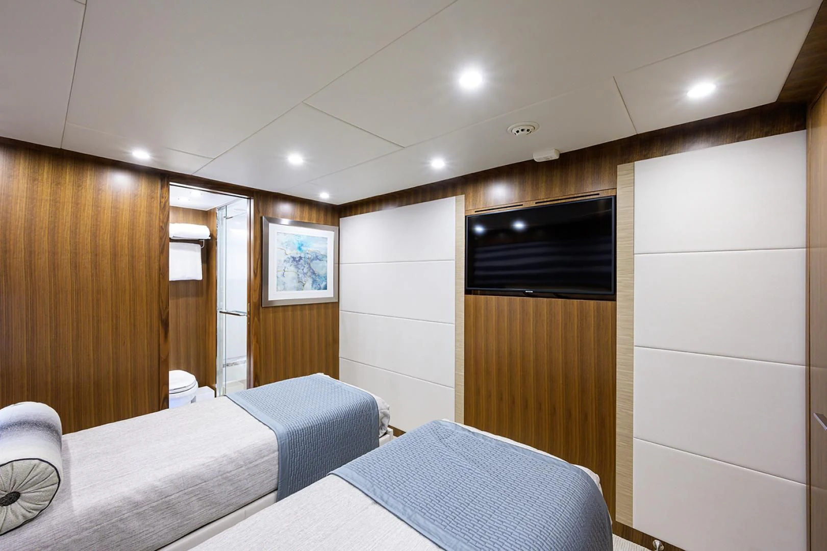 a room with a bed and a television aboard RISK TAKER Yacht for Charter