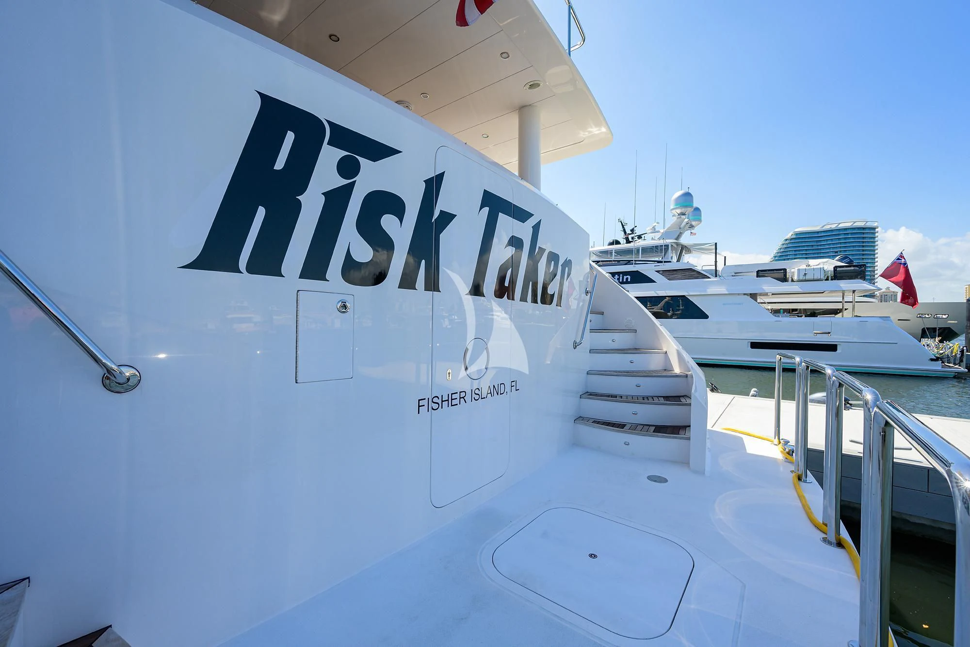 a large white boat with a sign on it aboard RISK TAKER Yacht for Charter