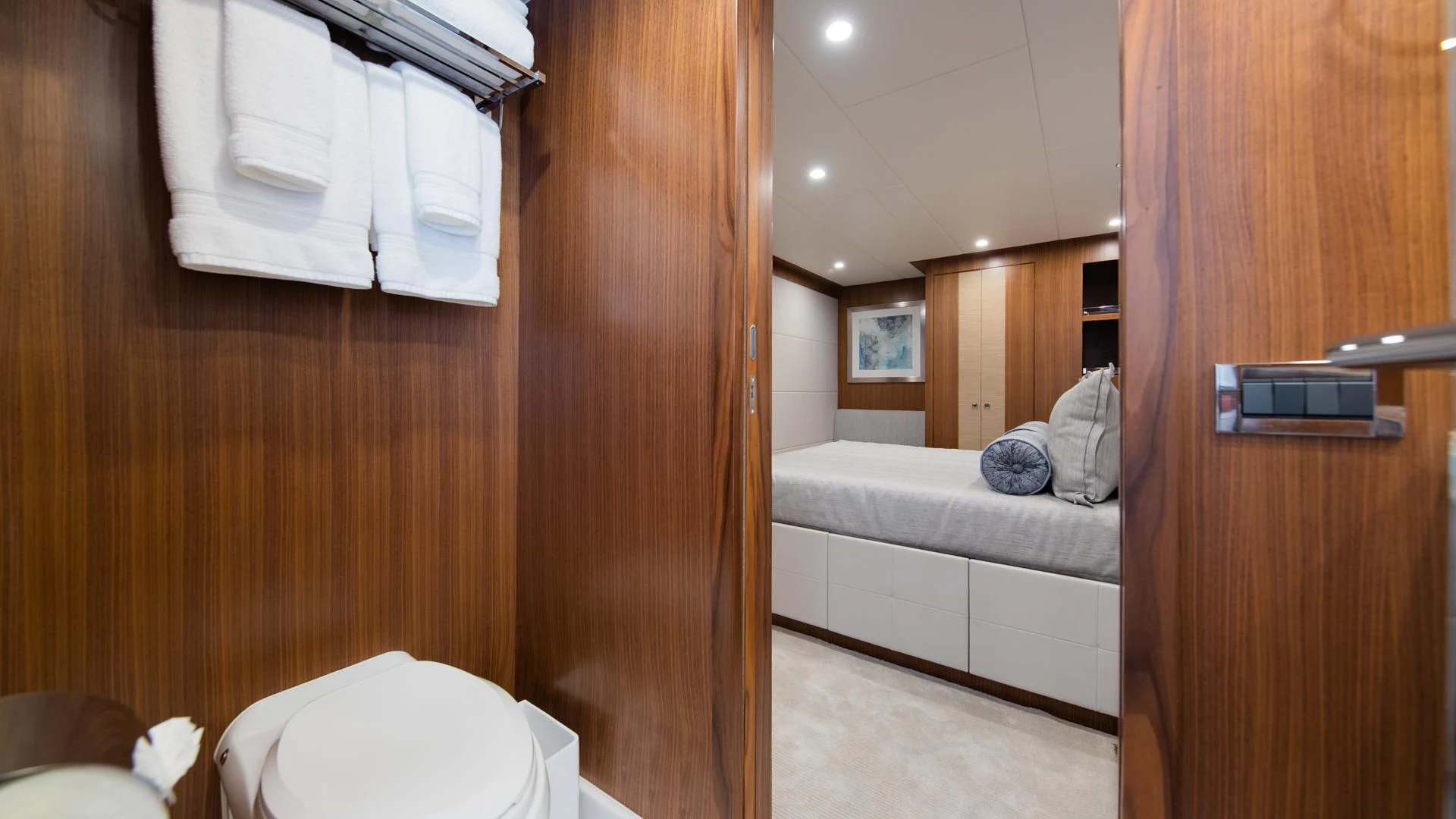 a bathroom with a wood door aboard RISK TAKER Yacht for Charter