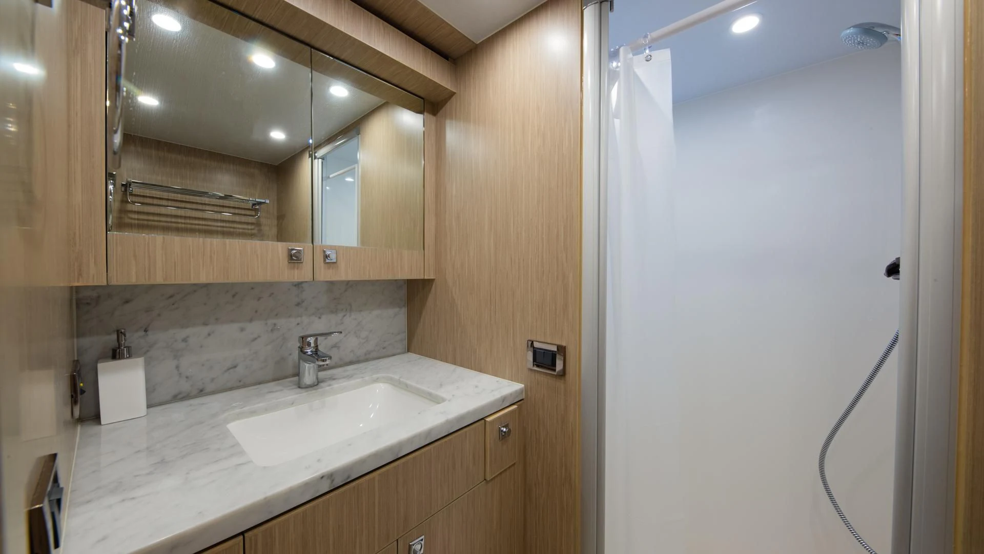 a bathroom with a sink and a mirror aboard RISK TAKER Yacht for Charter