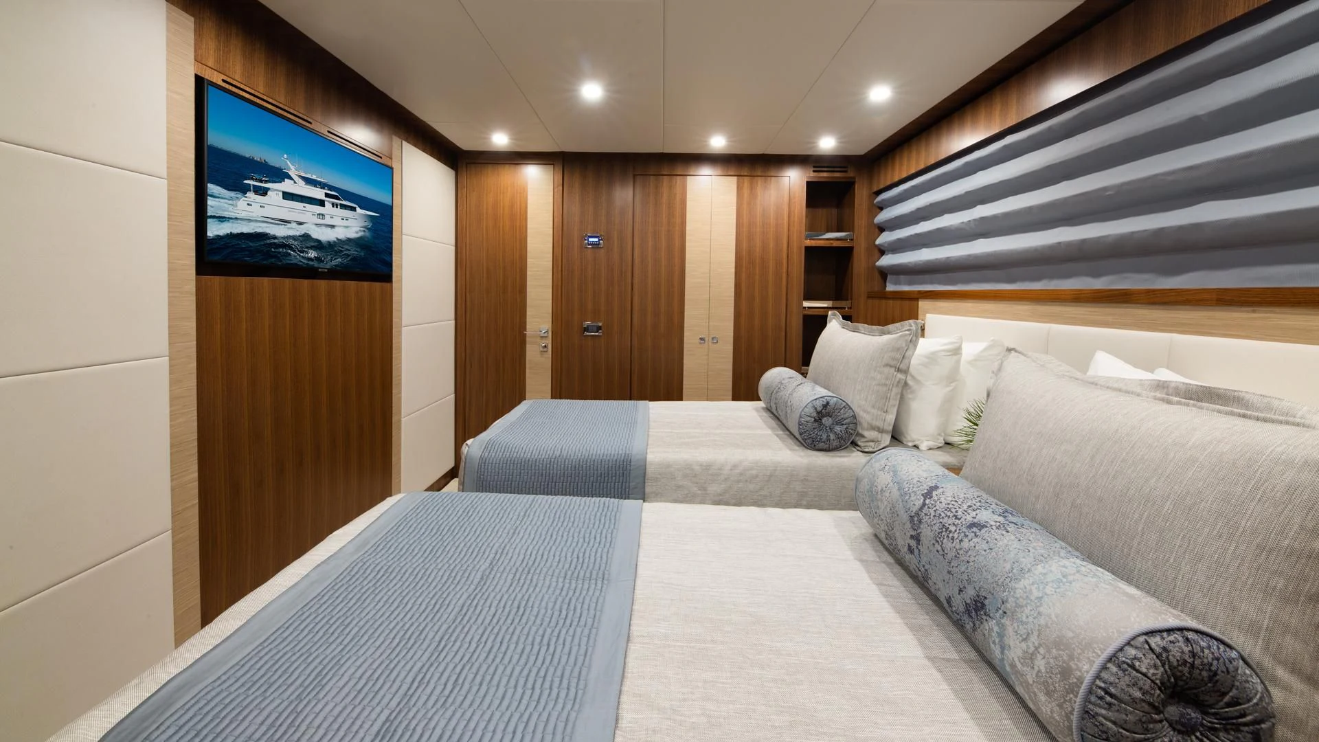 a bed and a television in a room aboard RISK TAKER Yacht for Charter