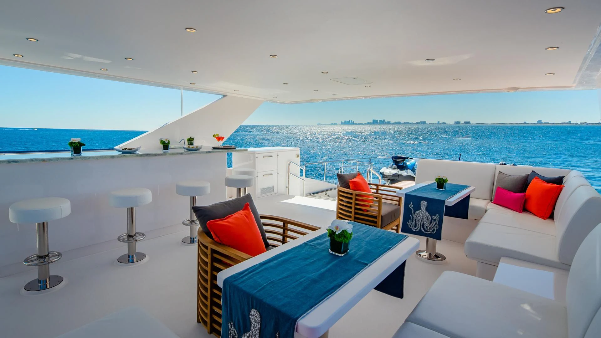 a room with a table chairs and a large window aboard RISK TAKER Yacht for Charter