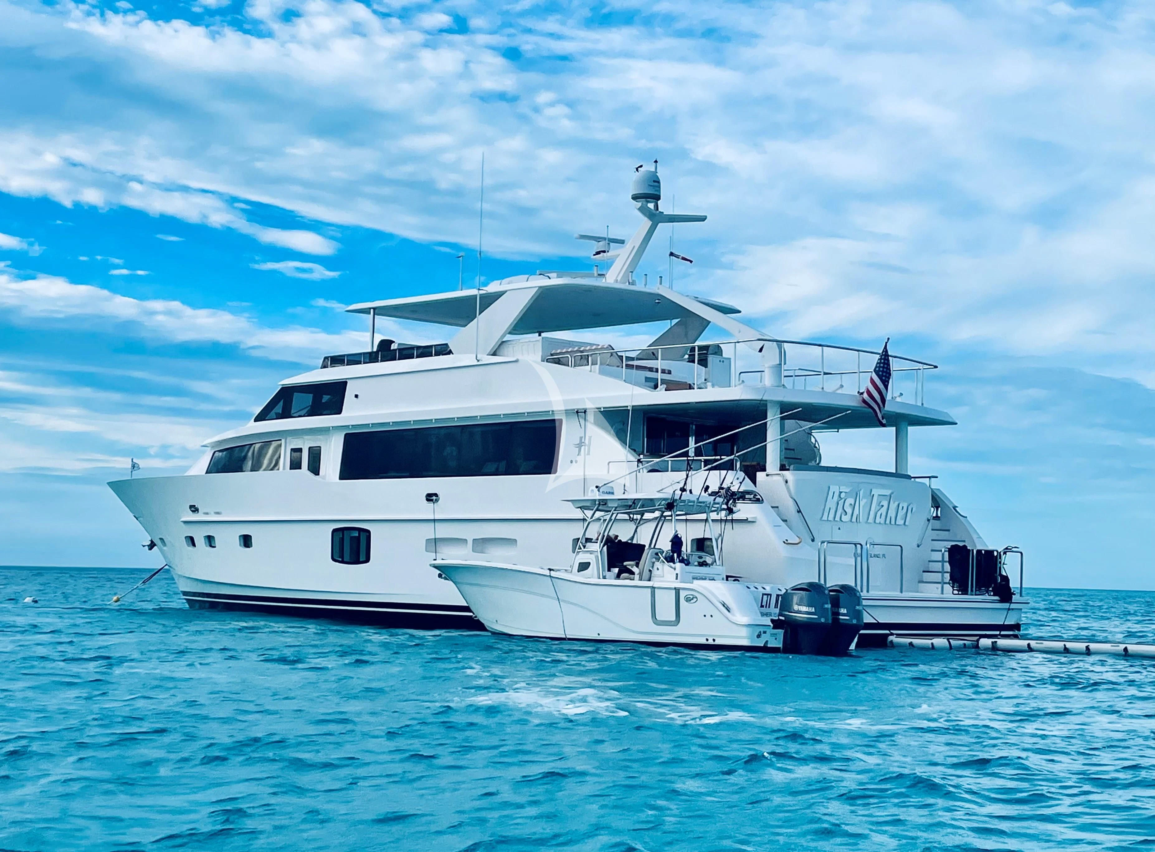 a large white boat in the water aboard RISK TAKER Yacht for Charter