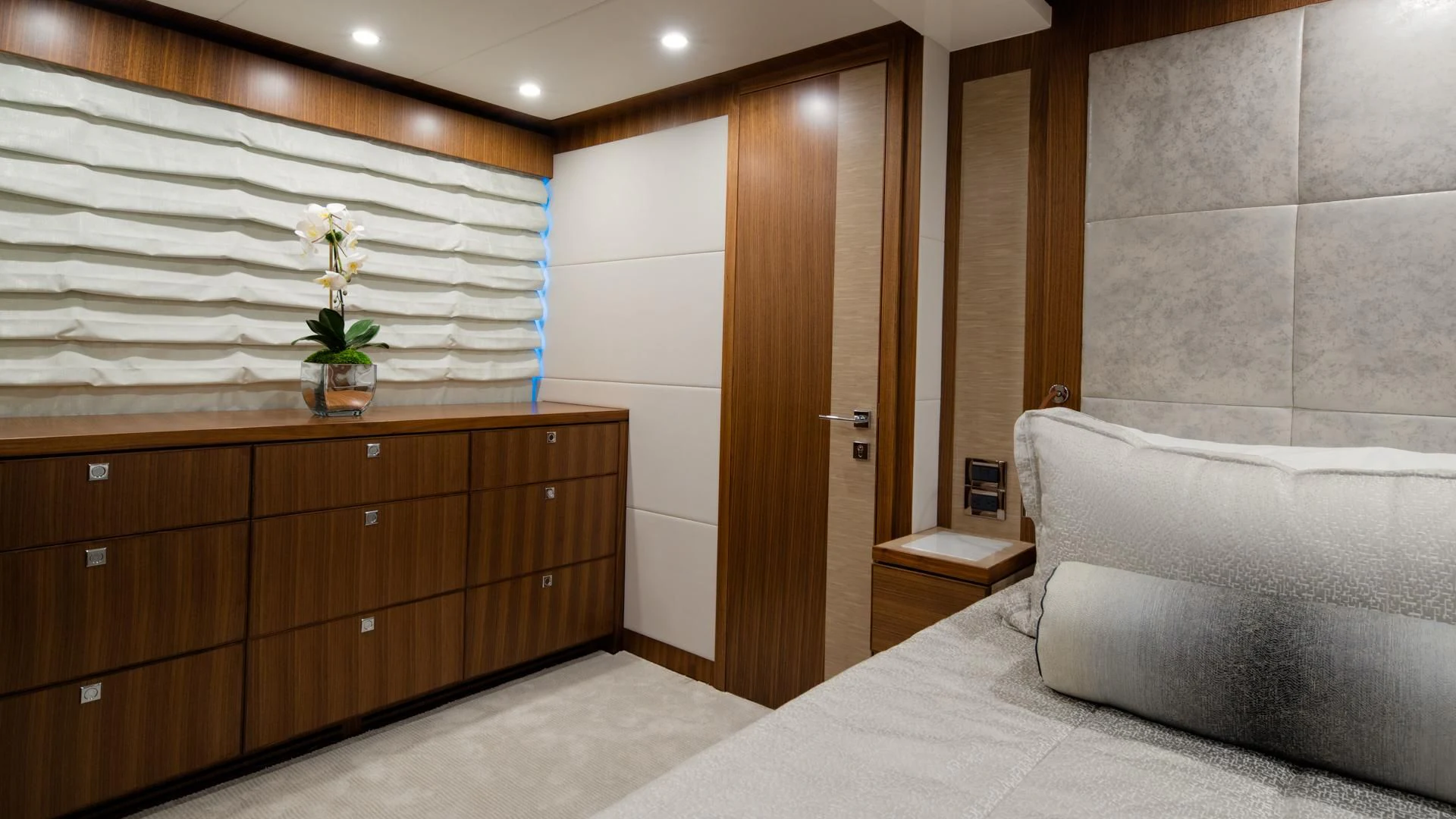 a room with a bed and a chair aboard RISK TAKER Yacht for Charter