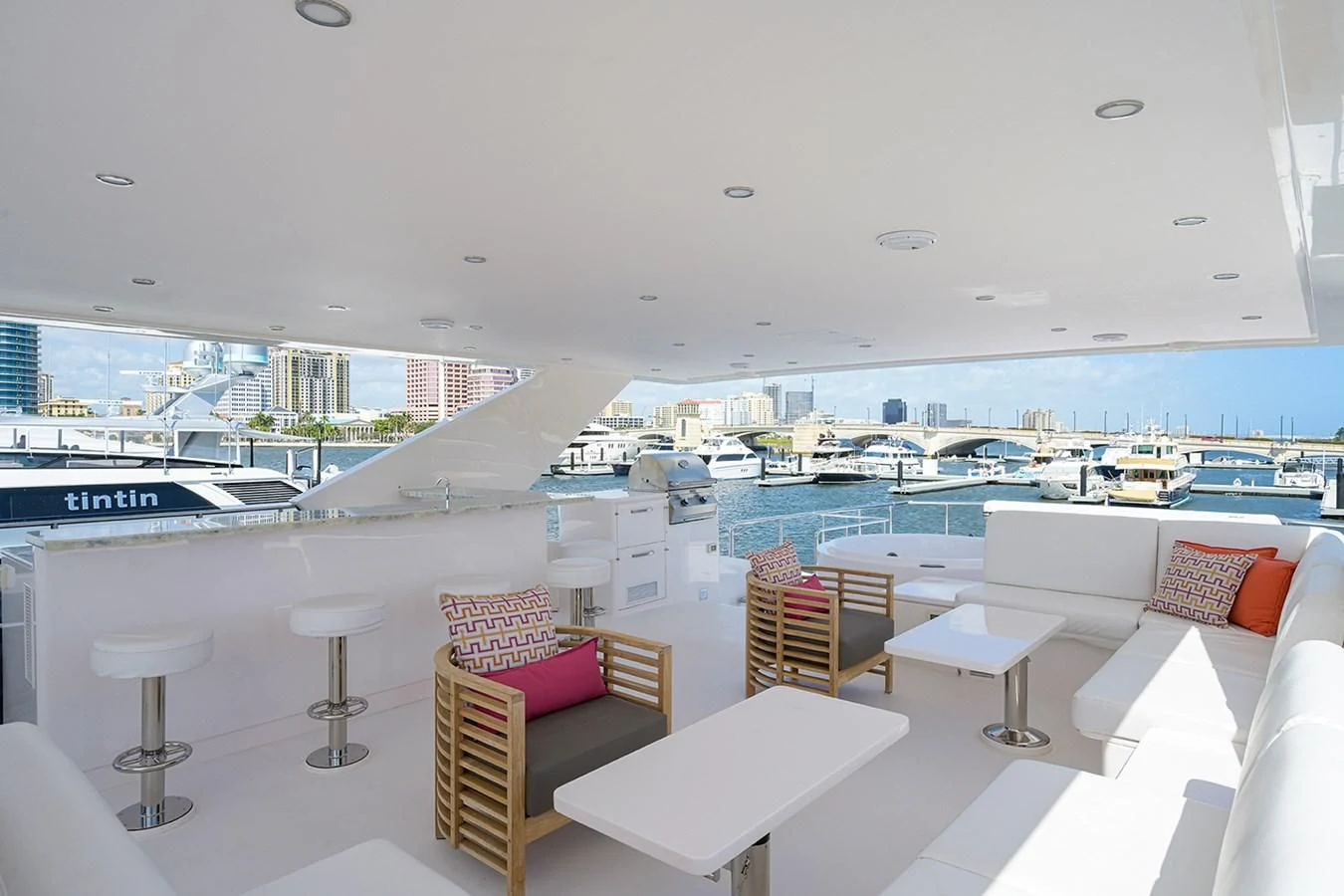 a room with a view of a city and a large pool aboard RISK TAKER Yacht for Charter