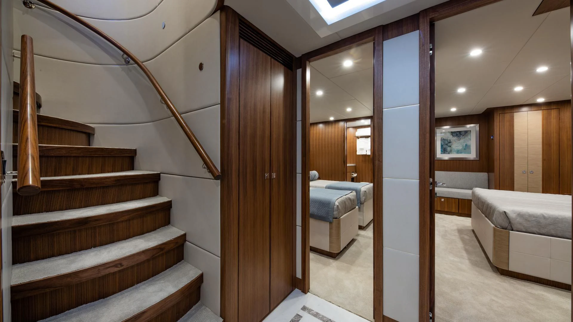 a room with wooden stairs and a bed aboard RISK TAKER Yacht for Charter