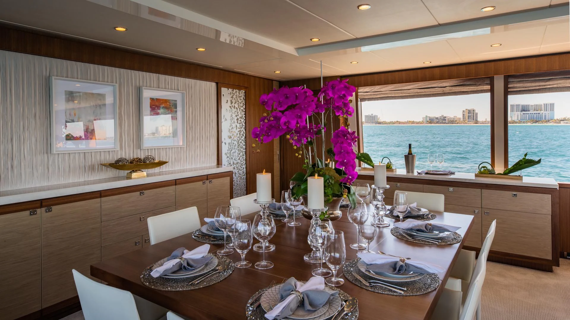 a dining table with a view of the ocean and the ocean aboard RISK TAKER Yacht for Charter