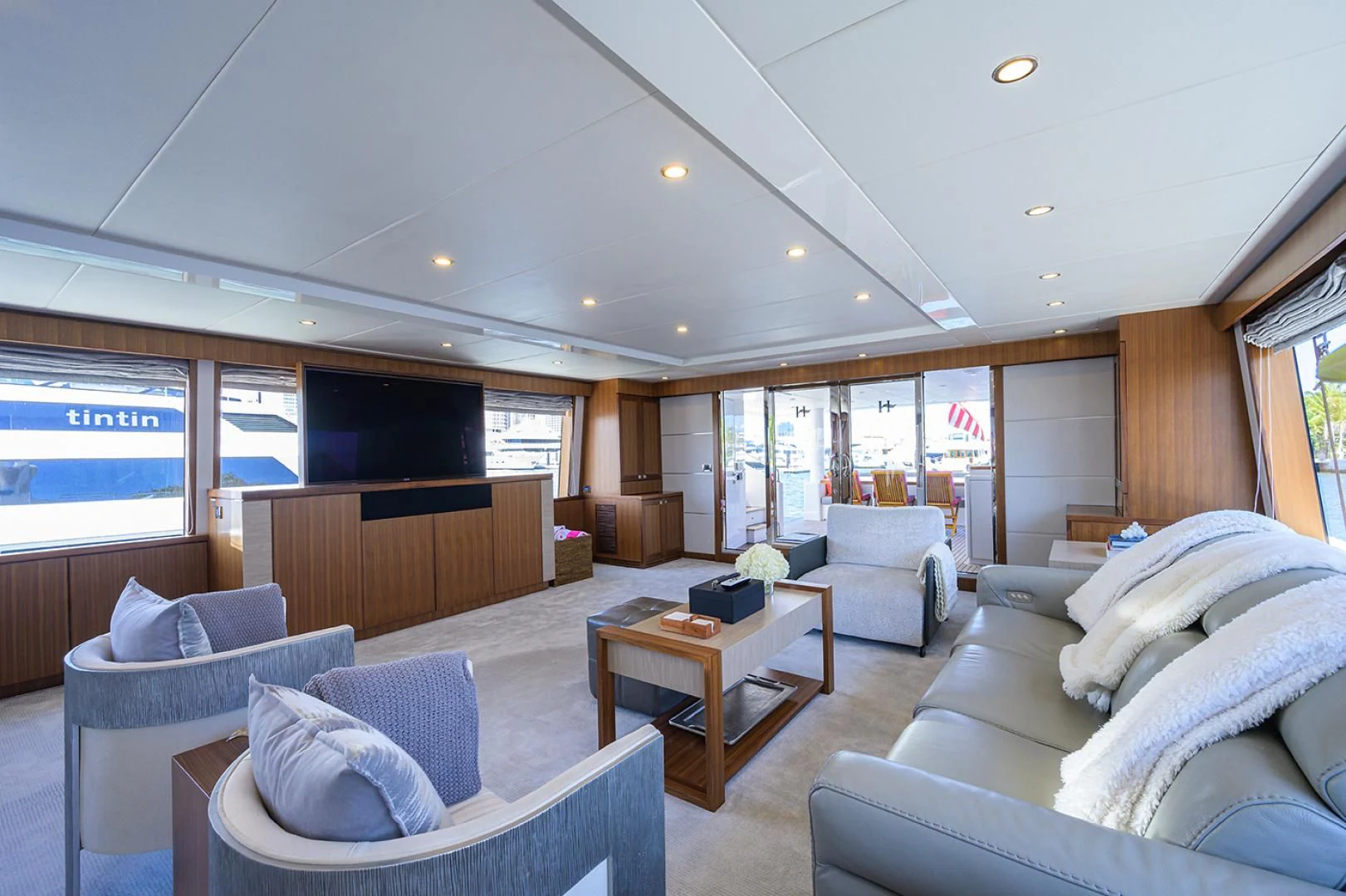 a living room with a large window aboard RISK TAKER Yacht for Charter
