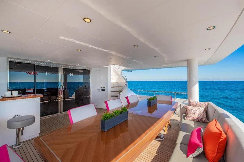 a living room with a large balcony aboard RISK TAKER Yacht for Charter