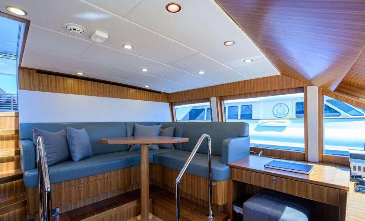 a room with a couch and a table aboard RISK TAKER Yacht for Charter