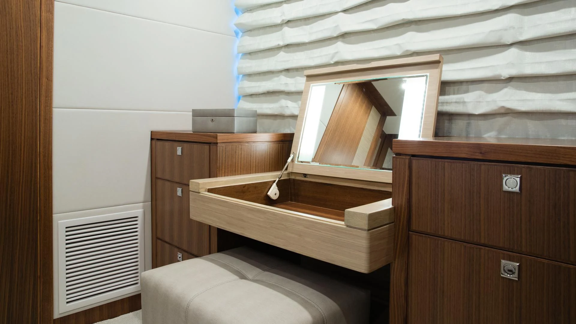 a room with a bed and a dresser aboard RISK TAKER Yacht for Charter