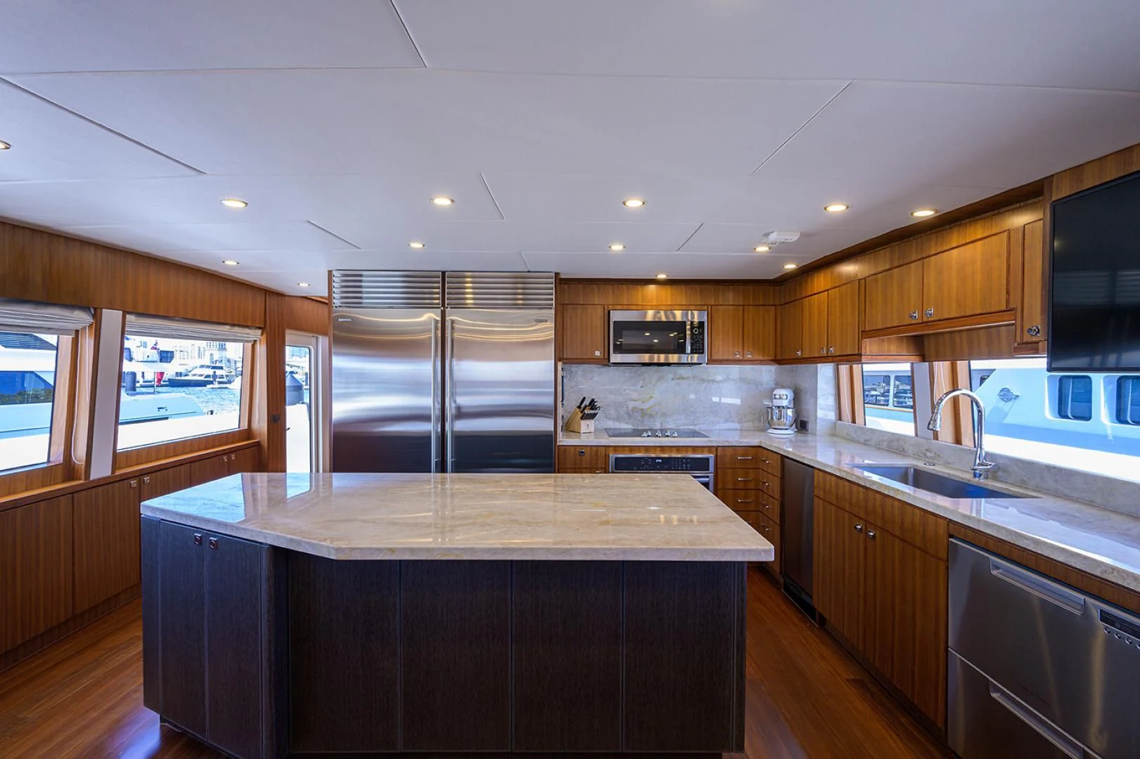 a kitchen with wooden cabinets aboard RISK TAKER Yacht for Charter