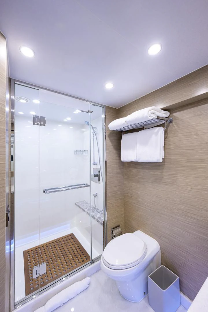 a bathroom with a glass shower aboard RISK TAKER Yacht for Charter